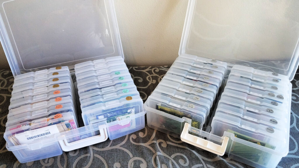 two open photo storage containers with multi-colored dot stickers